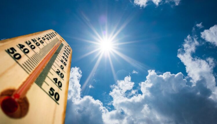 A spiking thermometer against a bright sky and hot sun