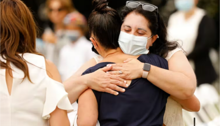 Two women embrace before a Yom Kippur service held outdoors during the COVID-19 pandemic in Los Angeles. Al Seib/Los Angeles Times via Getty Images