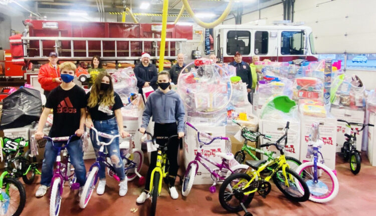 volunteers with the Uniontown Fire Department and Toys For Tots pose with the toys collected by area fire departments that totaled in the thousands for children in the area who would otherwise not receive toys this Christmas. The department will again serve as a drop-off place for the program (Herald-Standard photo).